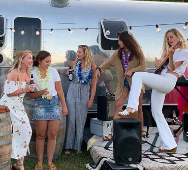 Girl band jamming outside Airstream